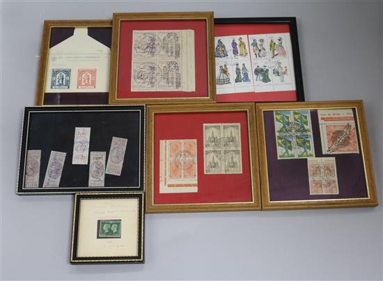 A small collection of framed decorative postage stamps,
